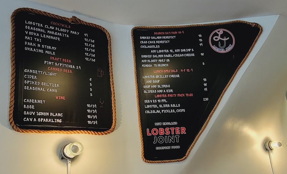 Menu board for lobster rolls and seafood.