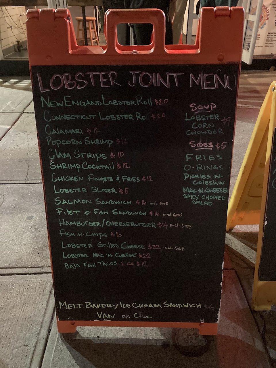 Seafood menu with sides and raw bar items.